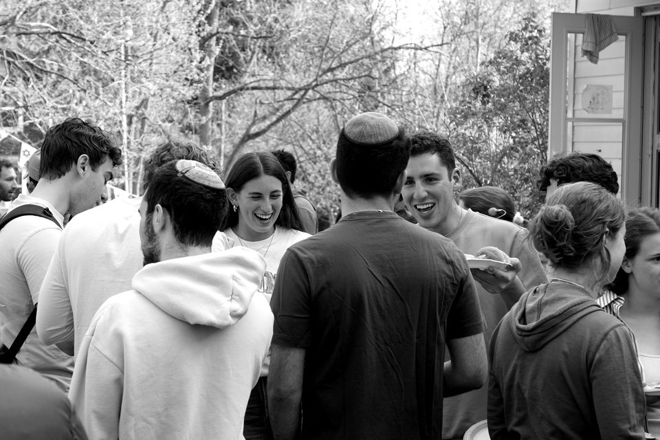 Students laughing together at an outdoor barbecue.